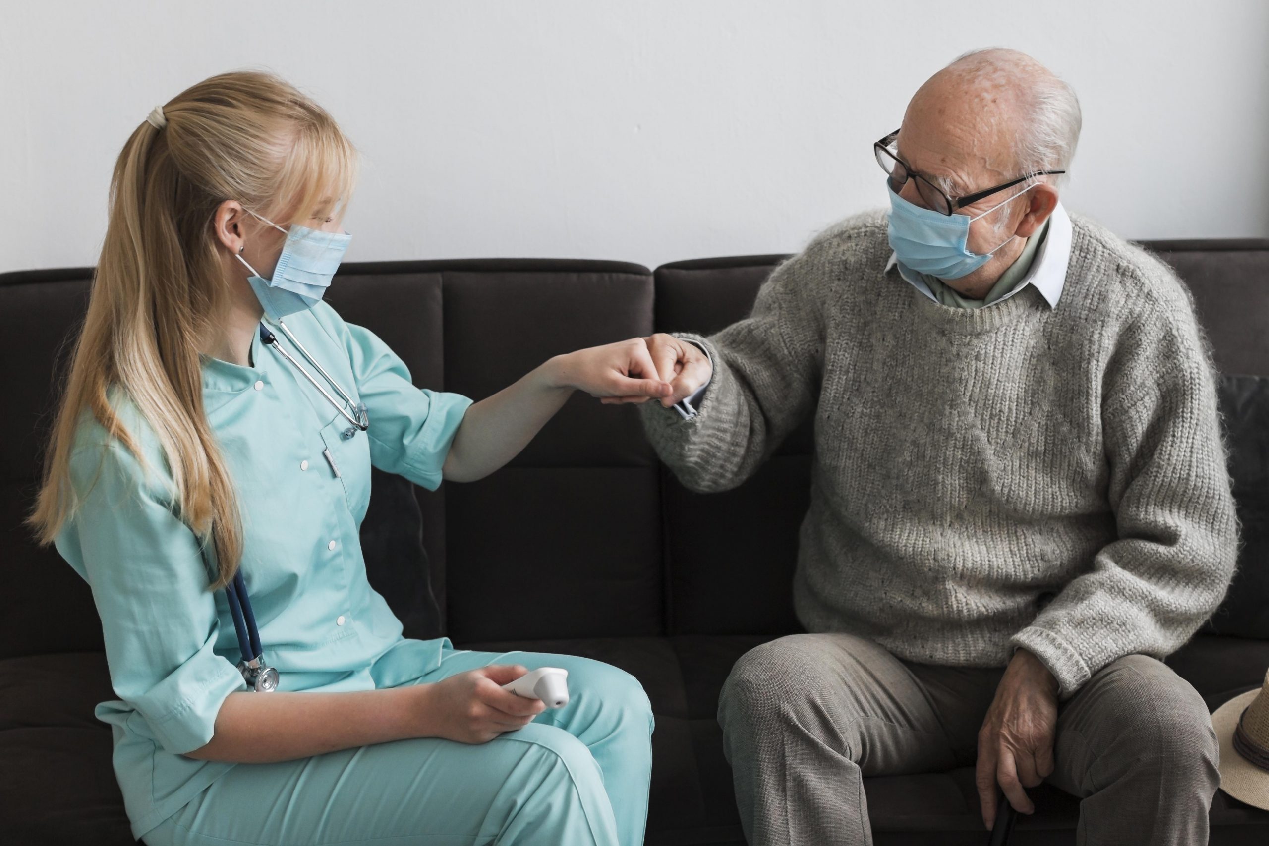 old-man-fist-bumping-nurse-nursing-home